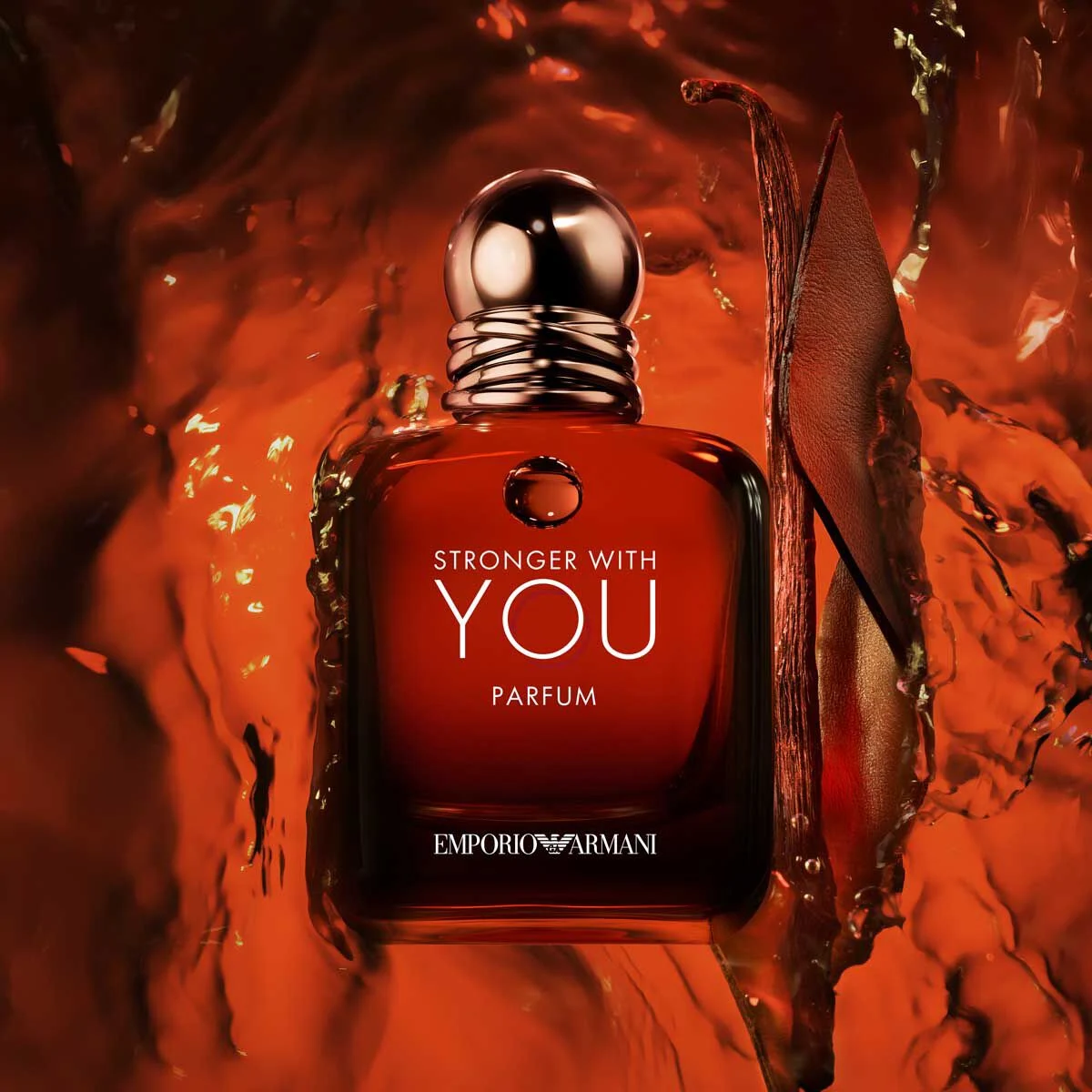 An Armani Stronger With You perfume bottle surrounded by amber reflections